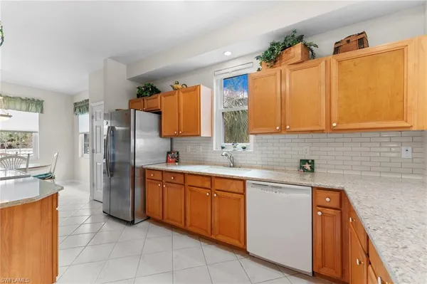 a kitchen with stainless steel appliances granite countertop a sink and cabinets
