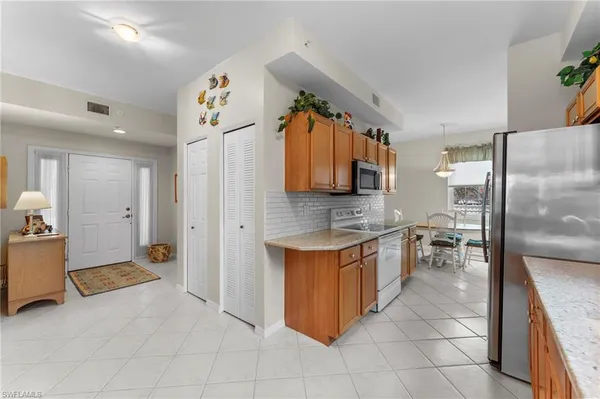 a kitchen with stainless steel appliances granite countertop a refrigerator and a sink