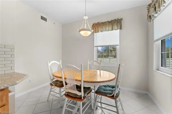 a dining room with furniture and window