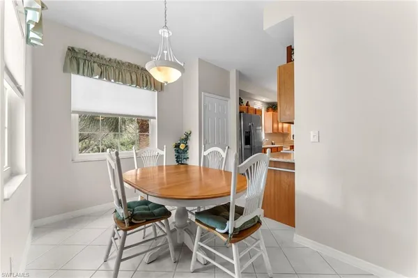 a dining room with furniture and window