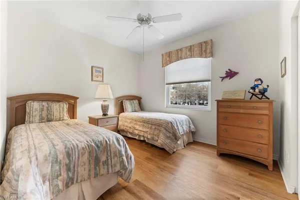 a bedroom with two beds and a dresser