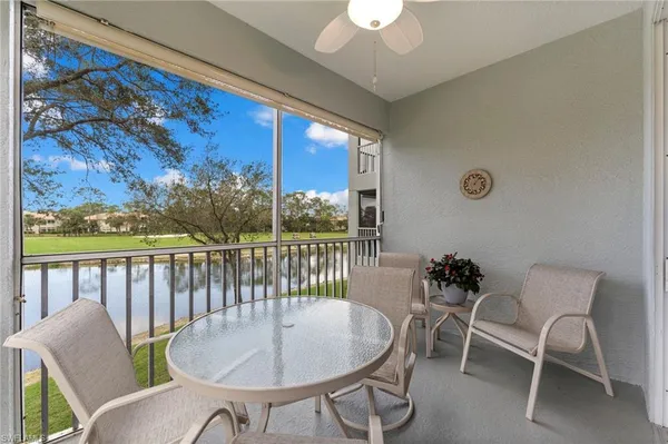 a balcony with table and chairs