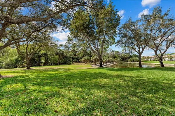 a view of grassy field with trees
