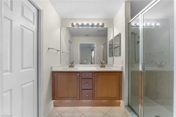 a bathroom with a double vanity sink and a mirror