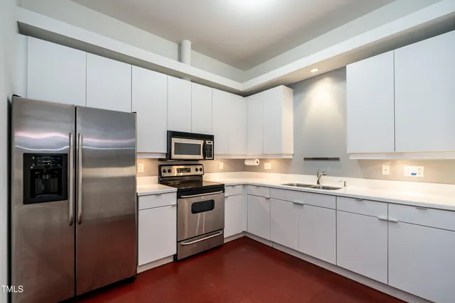 a kitchen with a sink cabinets and stainless steel appliances