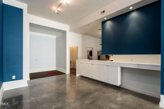 a view of a hallway with a kitchen