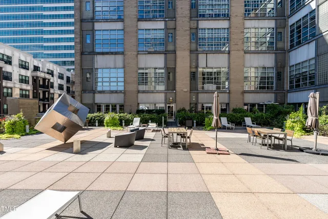 a row of palm trees in front of a building
