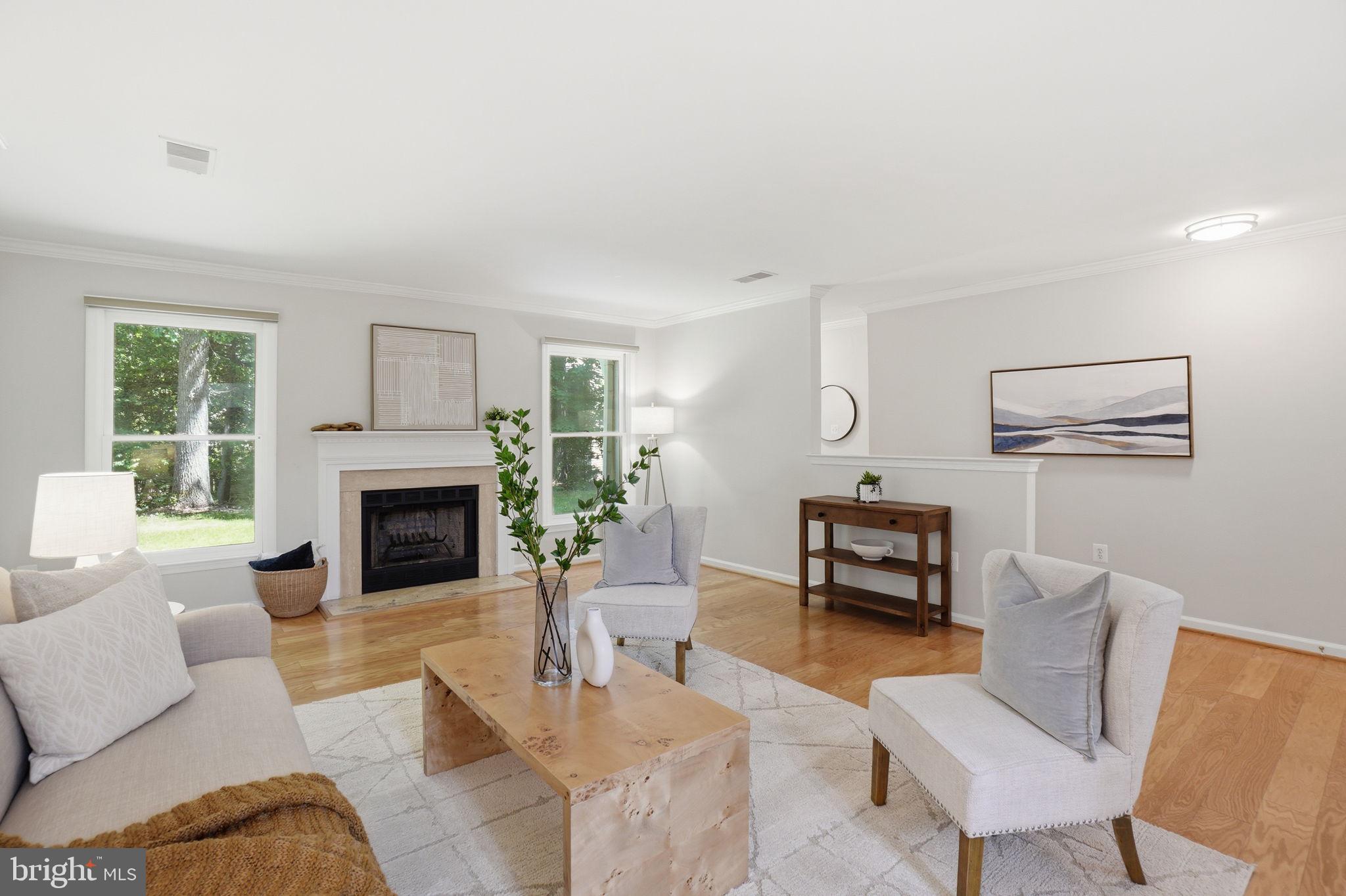 1495 Church Hill Place Reston, VA 20194 - Photo 7 of 27 a living room with furniture a fireplace and a table