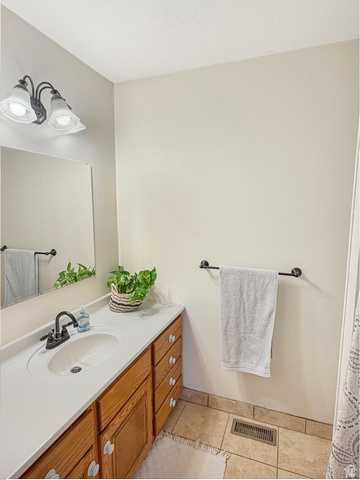 1716 Sagewood Road Price, UT 84501 - Photo 34 of 73 Full bathroom with vanity, light tile patterned floors, and a shower with curtain