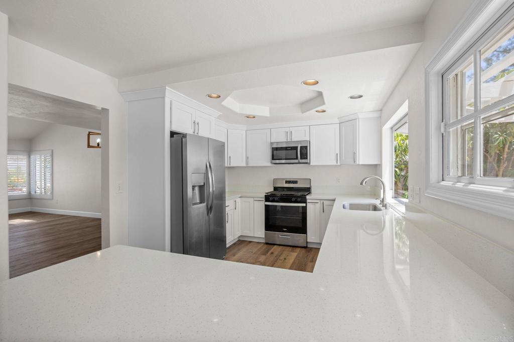 4595 Blackwell Road Oceanside, CA 92056 - Photo 11 of 47 a kitchen with stainless steel appliances a refrigerator stove microwave and sink