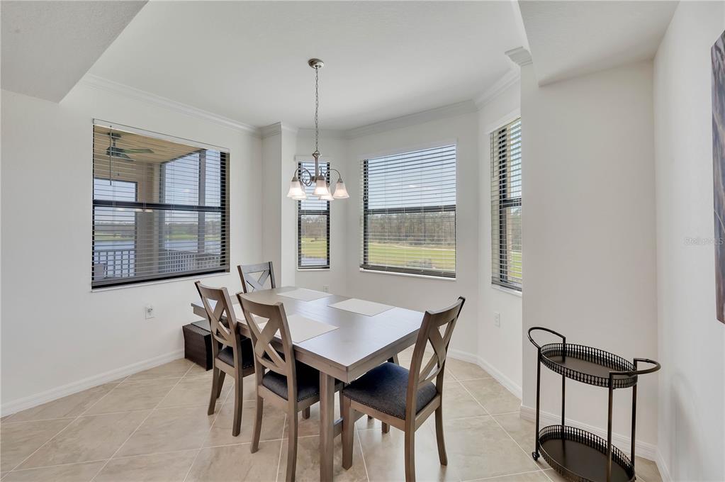17510 Gawthrop Drive, Unit 203 Lakewood Ranch, FL 34211 - Photo 11 of 54 a view of a dining room with furniture and window