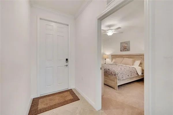 a bedroom with bed and a chandelier