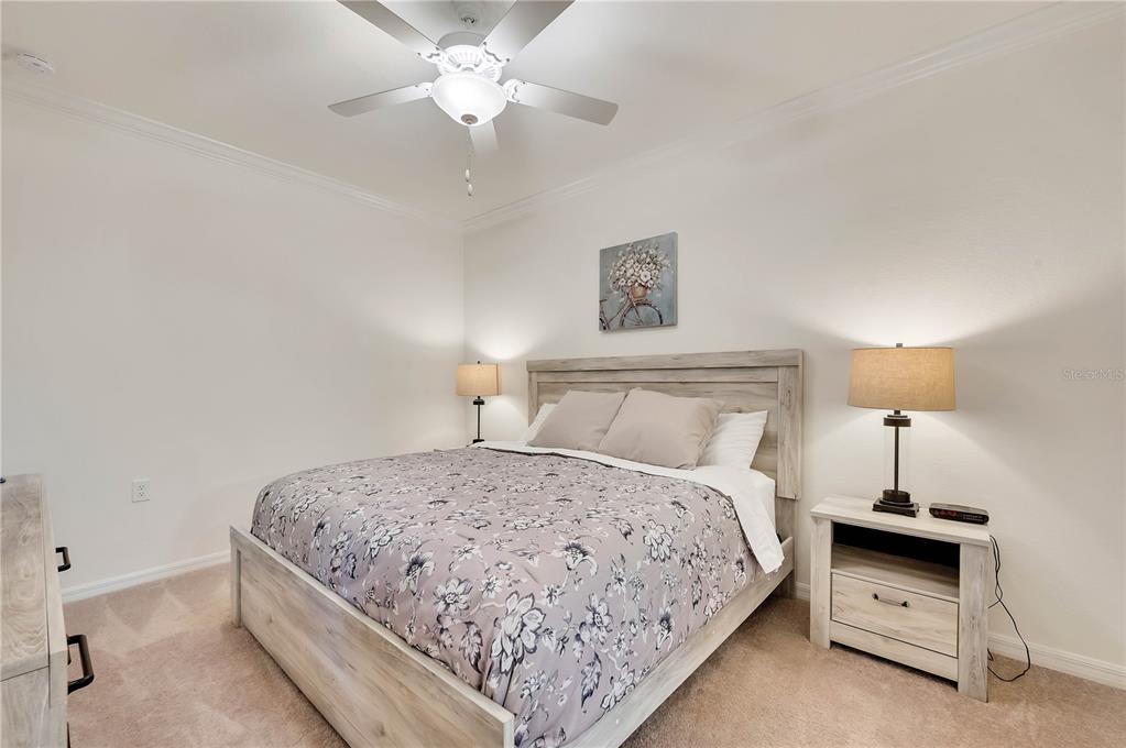 17510 Gawthrop Drive, Unit 203 Lakewood Ranch, FL 34211 - Photo 15 of 54 a bedroom with bed and a chandelier