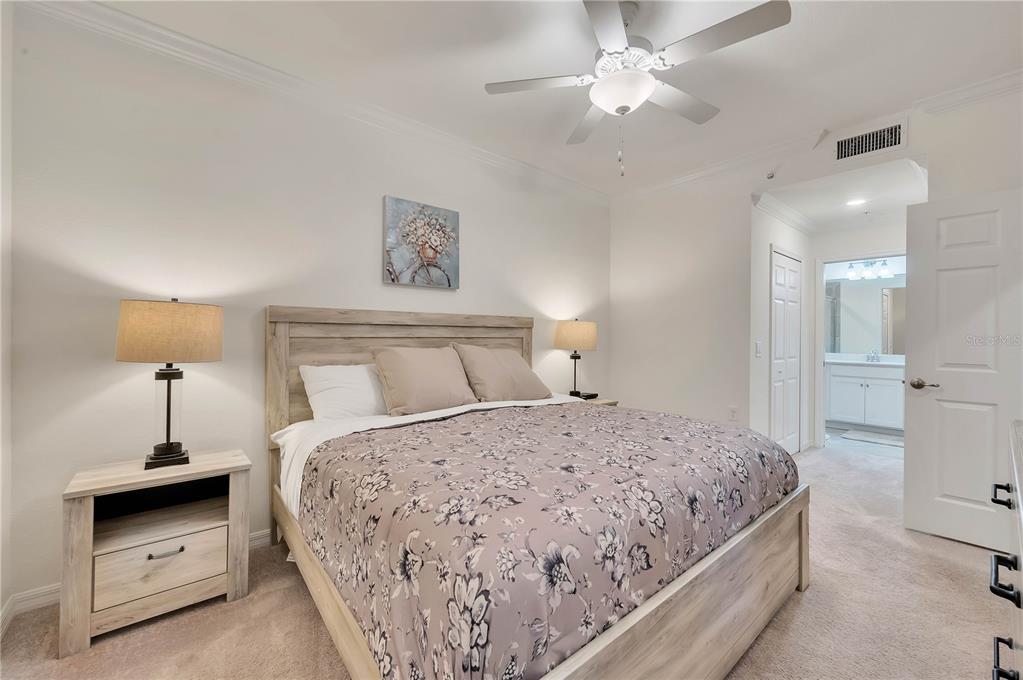 17510 Gawthrop Drive, Unit 203 Lakewood Ranch, FL 34211 - Photo 16 of 54 a bedroom with a bed and a ceiling fan