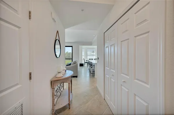 a view of a hallway to a livingroom and a dinning room with wooden floor