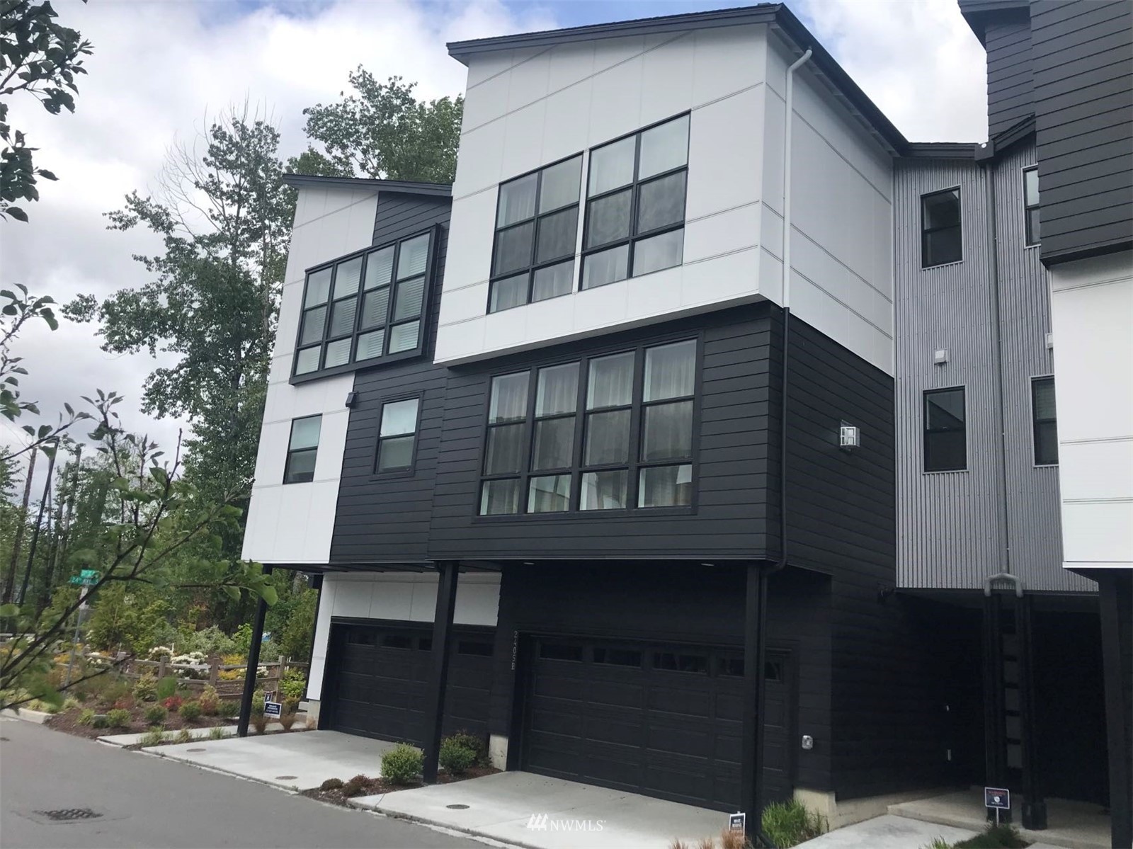 2405 217th Street Southeast, Unit B Bothell, WA 98021 - Photo 1 of 27 a front view of a house with a garden