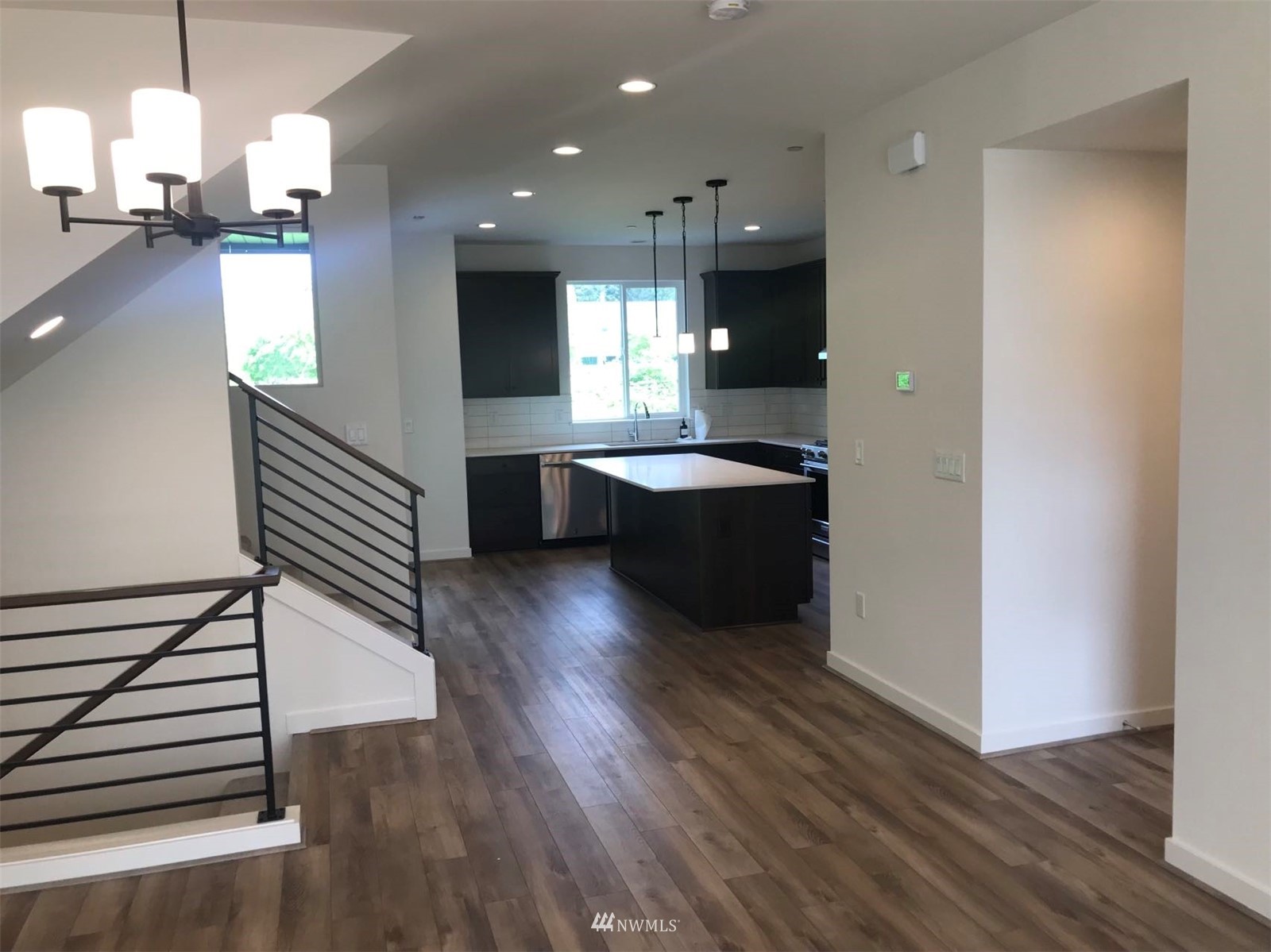 2405 217th Street Southeast, Unit B Bothell, WA 98021 - Photo 16 of 27 an open kitchen with wooden floor and windows