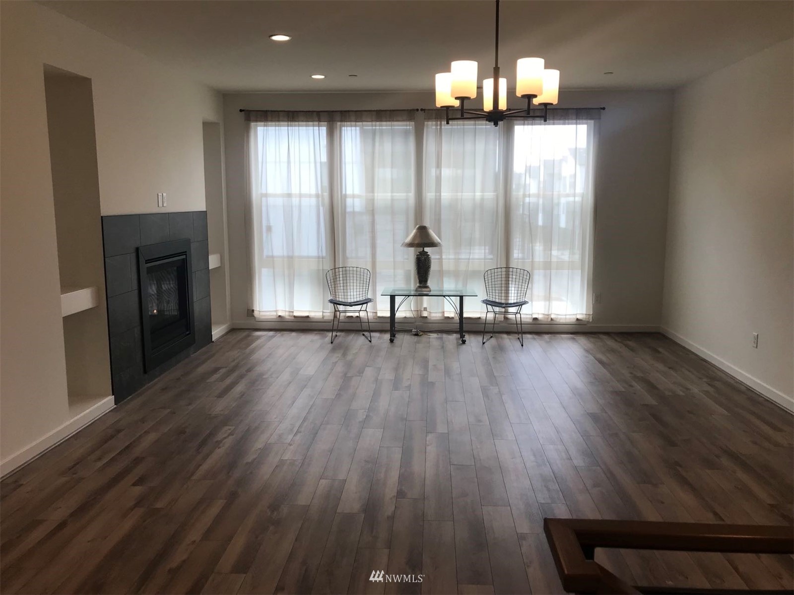 2405 217th Street Southeast, Unit B Bothell, WA 98021 - Photo 17 of 27 a view of a room with wooden floor and a floor to ceiling window