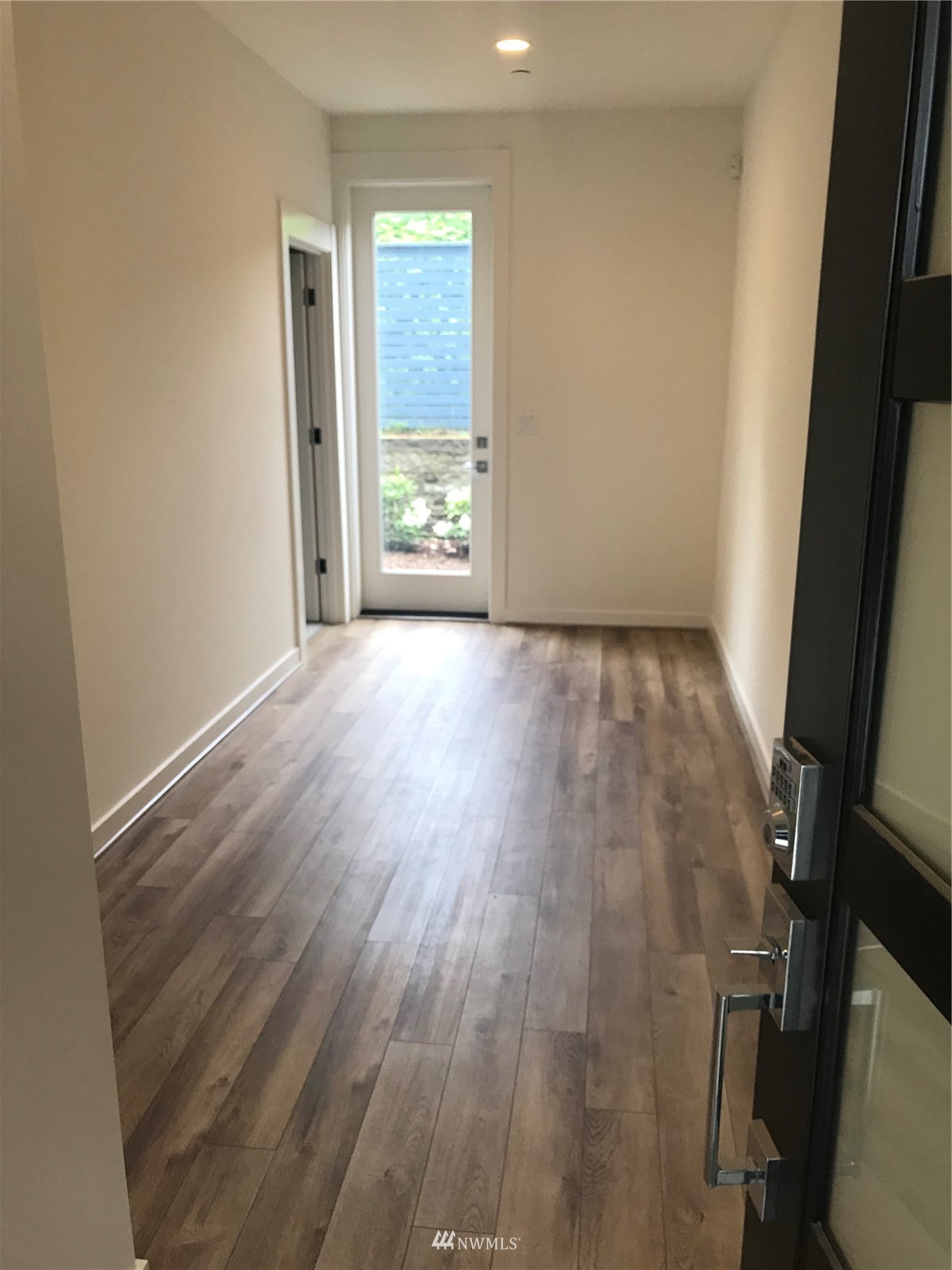 2405 217th Street Southeast, Unit B Bothell, WA 98021 - Photo 4 of 27 an empty room with wooden floor and windows