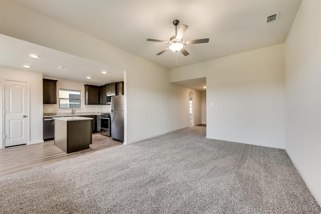 9516 Teton Vista Drive Fort Worth, TX 76140 - Photo 4 of 11 a view of a kitchen with a sink and a refrigerator