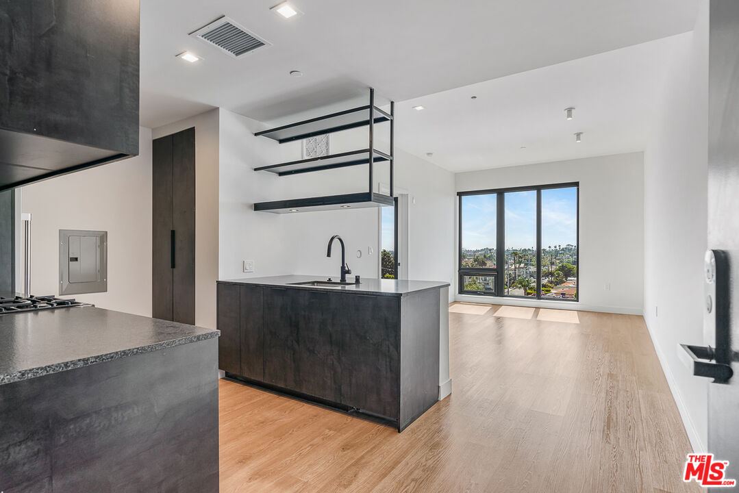 10700 Tabor Street, Unit 524 Los Angeles, CA 90034 - Photo 1 of 12 a view of a living room washer and dryer