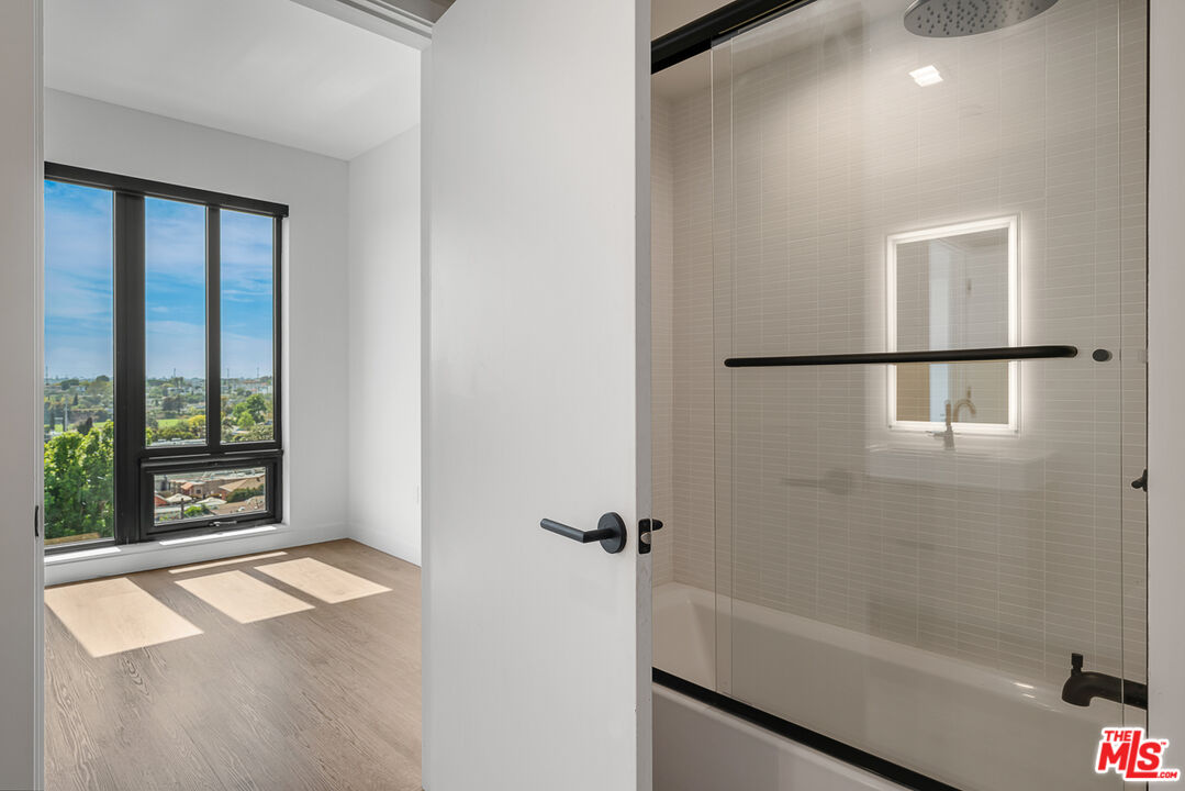 10700 Tabor Street, Unit 524 Los Angeles, CA 90034 - Photo 9 of 12 a bathroom with a bathtub and a shower