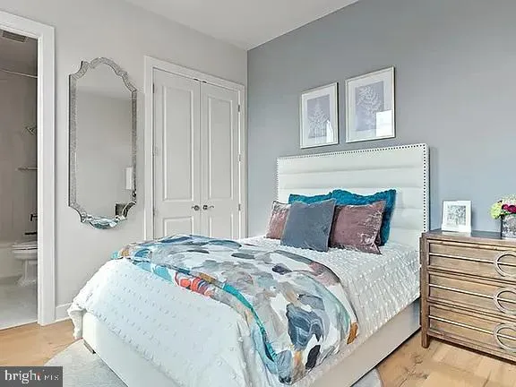 a bedroom with a bed and a mirror
