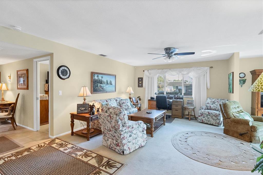 3990 Overlook Bend Terrace, Unit 19 Sarasota, FL 34232 - Photo 13 of 29 a living room with furniture wooden floor and a large window