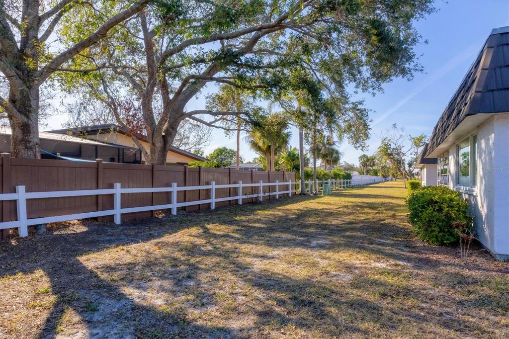 3990 Overlook Bend Terrace, Unit 19 Sarasota, FL 34232 - Photo 20 of 29 a view of a yard with wooden fence