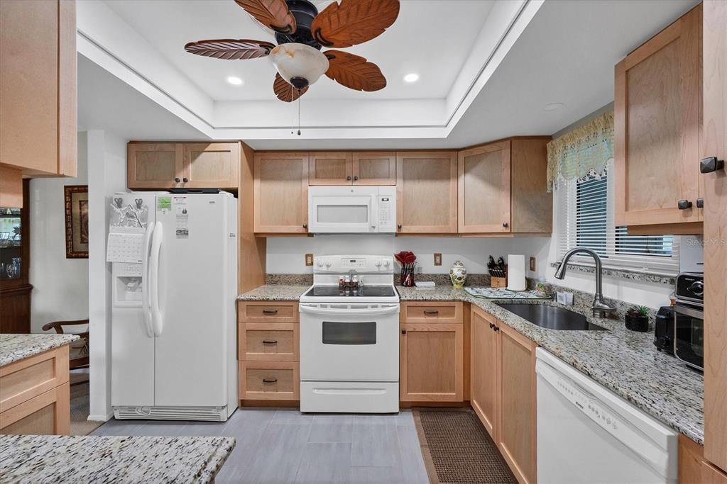 3990 Overlook Bend Terrace, Unit 19 Sarasota, FL 34232 - Photo 6 of 29 a kitchen with a refrigerator a sink and dishwasher