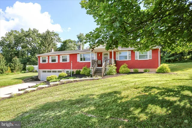 a front view of house with yard and green space