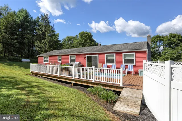 a front view of a house with a yard table and chairs