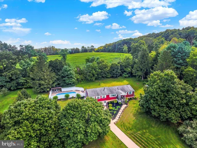a view of a swimming pool with an outdoor seating and yard