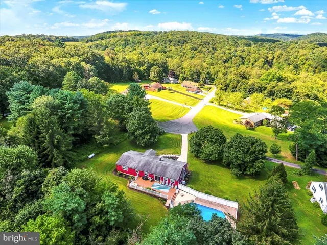 an aerial view of swimming pool patio and lake view