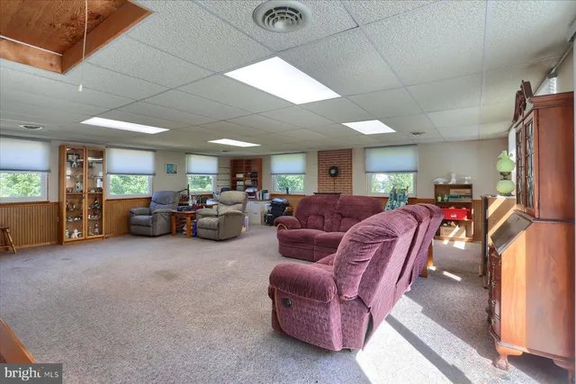 a living room with furniture a window and a flat screen tv