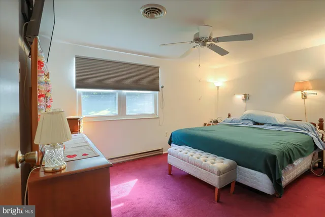 a bedroom with a bed and a dresser