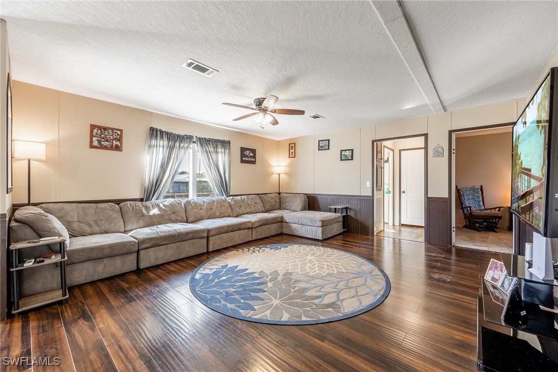 10491 Deal Road North Fort Myers, FL 33917 - Photo 18 of 48 a living room with furniture and a wooden floor