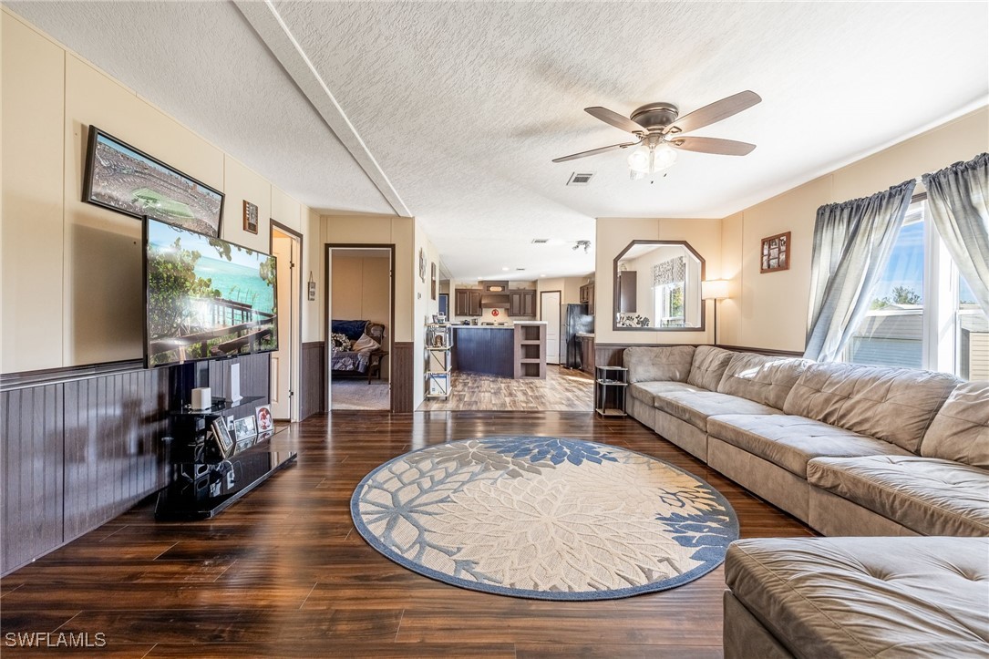 10491 Deal Road North Fort Myers, FL 33917 - Photo 19 of 48 a living room with furniture and a flat screen tv