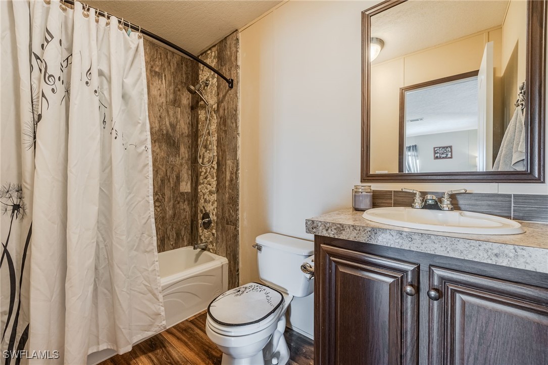10491 Deal Road North Fort Myers, FL 33917 - Photo 26 of 48 a bathroom with a granite countertop sink toilet and shower