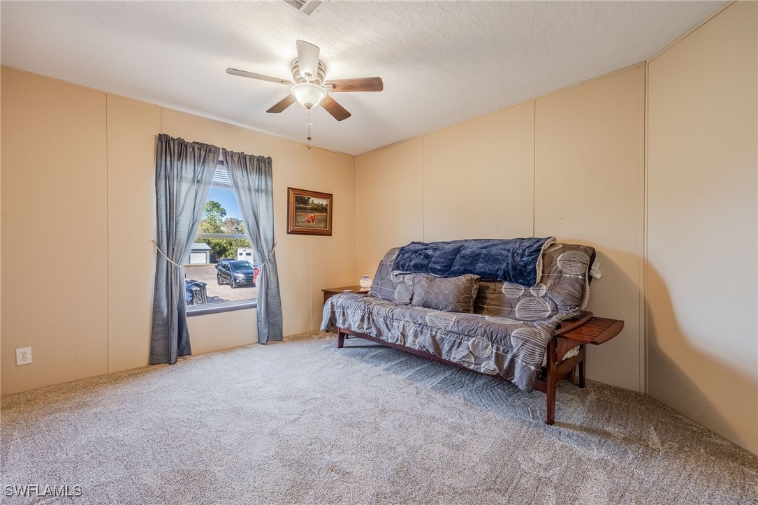 10491 Deal Road North Fort Myers, FL 33917 - Photo 27 of 48 a living room with furniture and a ceiling fan