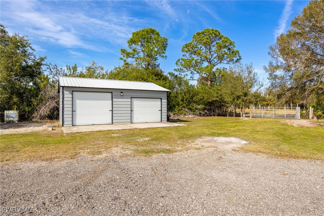 10491 Deal Road North Fort Myers, FL 33917 - Photo 30 of 48 a front view of house with yard and trees