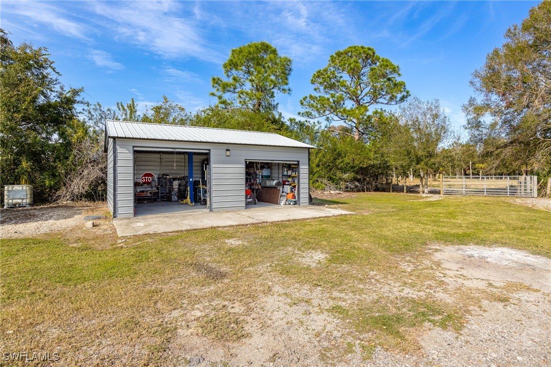 10491 Deal Road North Fort Myers, FL 33917 - Photo 31 of 48 a view of a house with swimming pool and a chairs