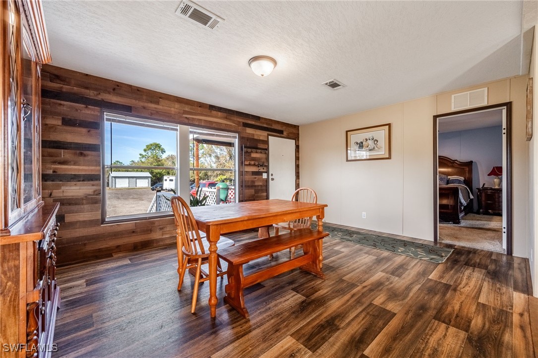 10491 Deal Road North Fort Myers, FL 33917 - Photo 7 of 48 a dining room with furniture and wooden floor