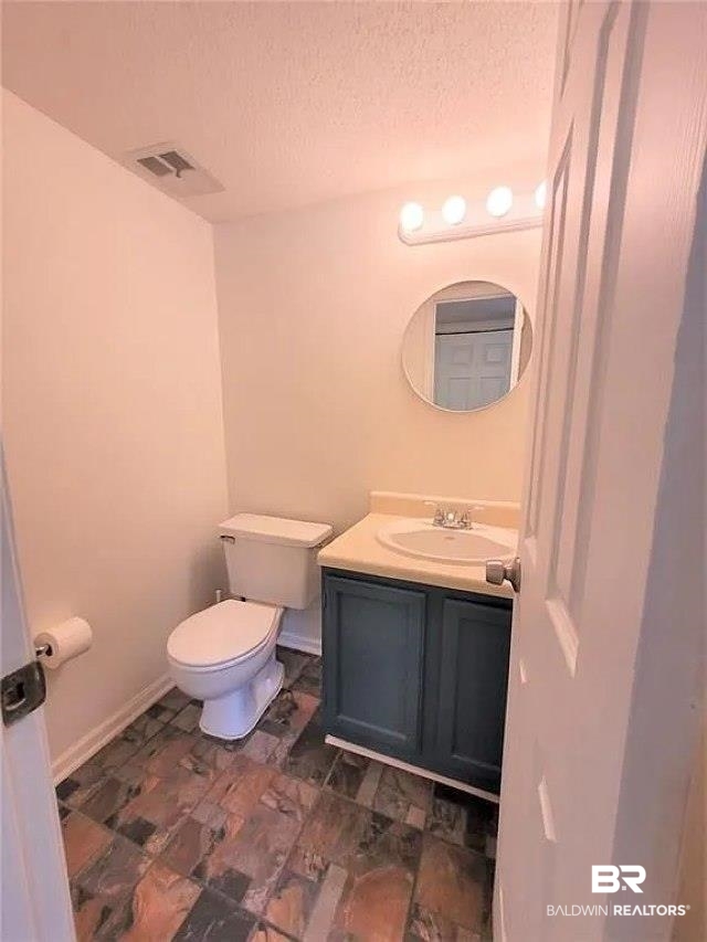 6701 Dickens Ferry Road, Unit 53 Mobile, AL 36608 - Photo 9 of 23 Bathroom featuring vanity and a textured ceiling