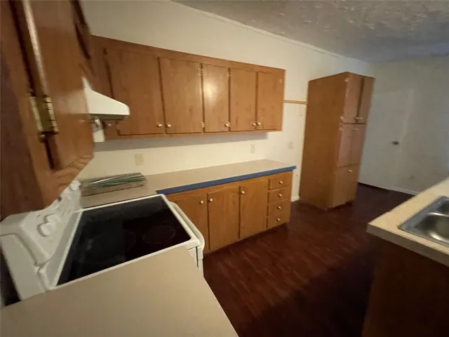 a kitchen with a refrigerator and a stove