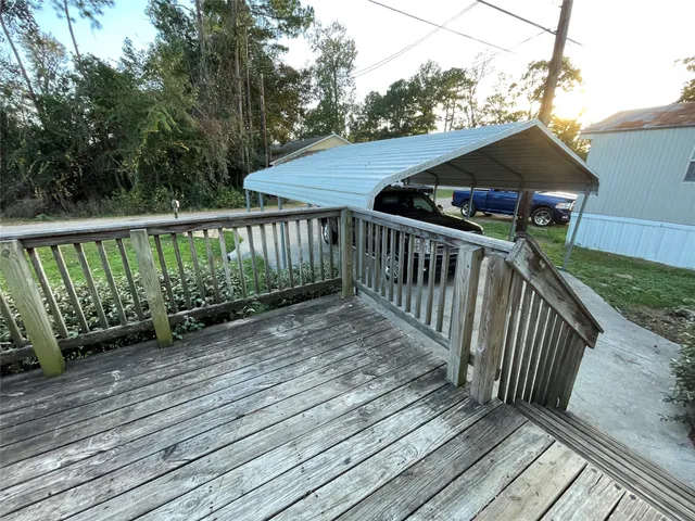 a view of balcony with wooden floor and fence