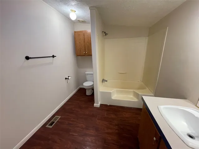 a bathroom with a sink a toilet and bathtub