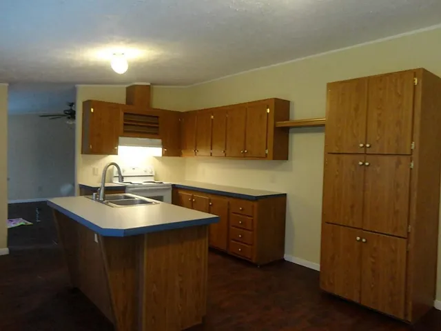a kitchen with sink cabinets and refrigerator