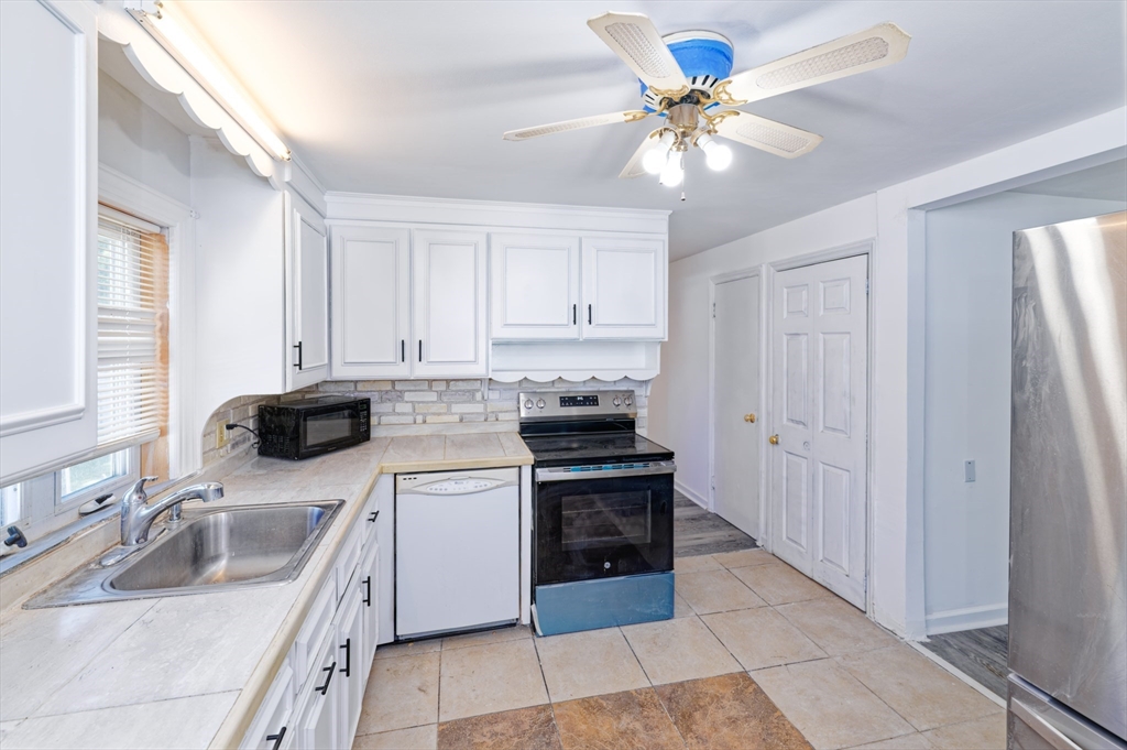 1 Rockland Rd Court Auburn, MA 01501 - Photo 13 of 38 a kitchen with stainless steel appliances granite countertop a sink a stove and a refrigerator