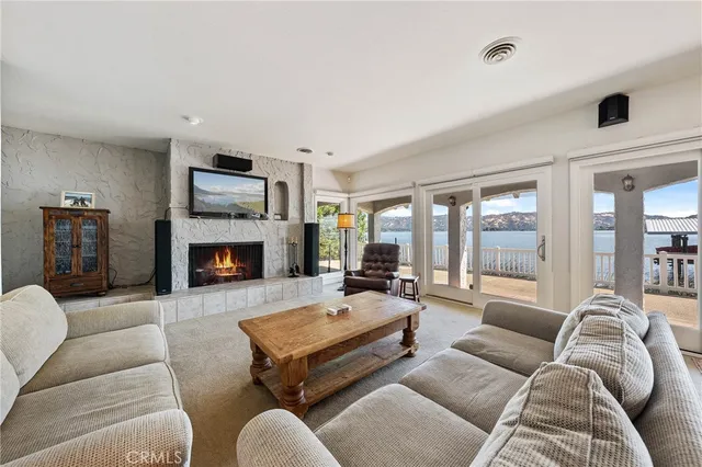 a living room with furniture fireplace and a large window